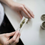 Photo: A stock image of an individual rolling up a joint.